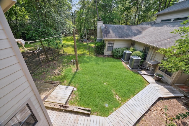 14111 Decker Dr, Magnolia, TX 77355 - view of yard featuring a wooden deck and central air condition unit