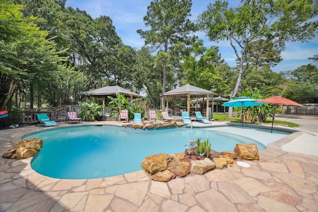 14111 Decker Dr, Magnolia, TX 77355 - view of swimming pool with a gazebo, a patio area, and view of wooded area