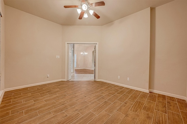 722 Silver Creek Cir, Richmond, TX 77406 - empty room featuring a chandelier, light wood-style flooring, ceiling fan, and baseboards