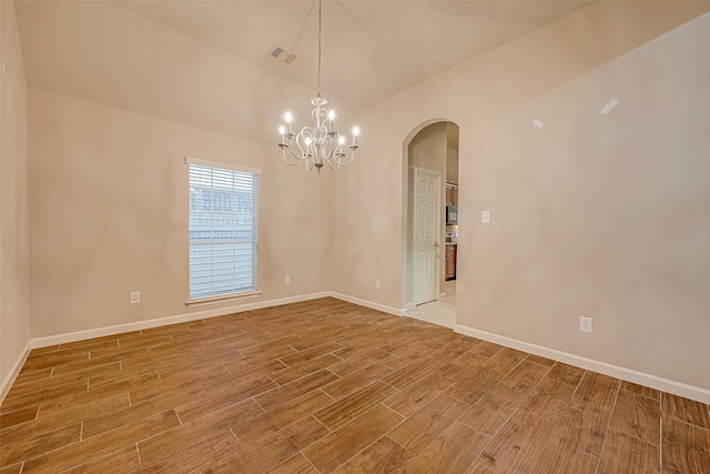 722 Silver Creek Cir, Richmond, TX 77406 - empty room with arched walkways, light wood-style floors, a chandelier, vaulted ceiling, and baseboards