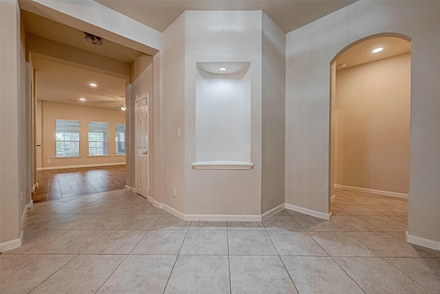 722 Silver Creek Cir, Richmond, TX 77406 - hall featuring light tile patterned floors, arched walkways, baseboards, and recessed lighting