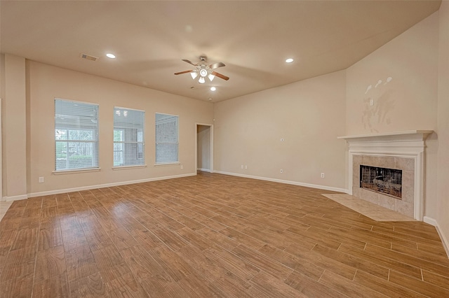 722 Silver Creek Cir, Richmond, TX 77406 - unfurnished living room with ceiling fan, a fireplace, light wood-type flooring, baseboards, and recessed lighting
