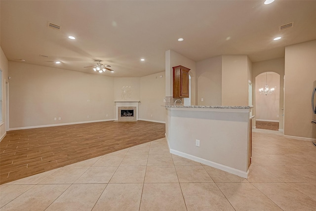 722 Silver Creek Cir, Richmond, TX 77406 - unfurnished living room featuring ceiling fan, recessed lighting, light tile patterned floors, baseboards, and a chandelier