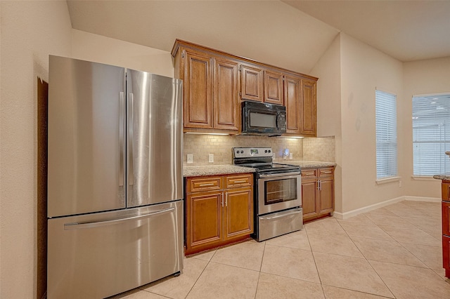 722 Silver Creek Cir, Richmond, TX 77406 - kitchen with stainless steel appliances, decorative backsplash, brown cabinetry, light tile patterned flooring, and baseboards
