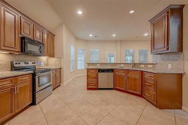 722 Silver Creek Cir, Richmond, TX 77406 - kitchen featuring stainless steel appliances, a sink, backsplash, light tile patterned floors, and recessed lighting