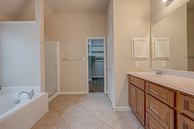 722 Silver Creek Cir, Richmond, TX 77406 - full bathroom with vanity, a garden tub, a walk in closet, a stall shower, and tile patterned flooring