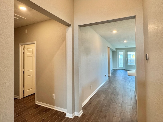 2115 Katalonia Ln, Fresno, TX 77545 - hallway featuring dark wood-style flooring, a textured wall, and baseboards