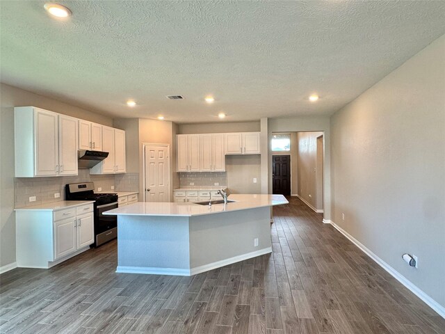 2115 Katalonia Ln, Fresno, TX 77545 - kitchen featuring stainless steel gas stove, a sink, dark wood-style floors, white cabinets, and a textured ceiling