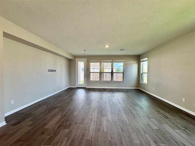 2115 Katalonia Ln, Fresno, TX 77545 - empty room with a textured ceiling, dark wood-style floors, baseboards, and recessed lighting