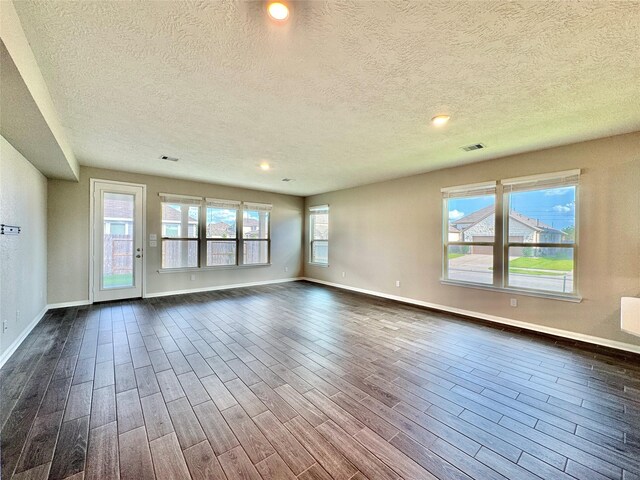 2115 Katalonia Ln, Fresno, TX 77545 - empty room featuring a textured ceiling, baseboards, dark wood-style flooring, and recessed lighting