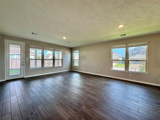 2115 Katalonia Ln, Fresno, TX 77545 - empty room with a textured ceiling, baseboards, dark wood-style flooring, and recessed lighting