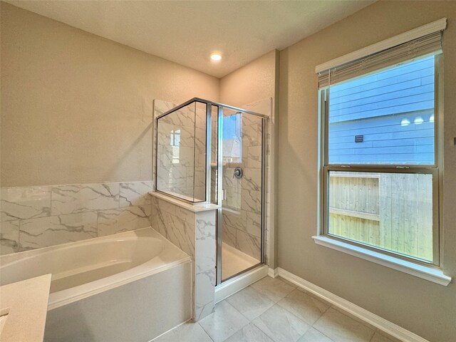 2115 Katalonia Ln, Fresno, TX 77545 - full bath with a bath, a stall shower, tile patterned flooring, and baseboards