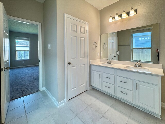 2115 Katalonia Ln, Fresno, TX 77545 - full bathroom with double vanity, baseboards, and tile patterned flooring