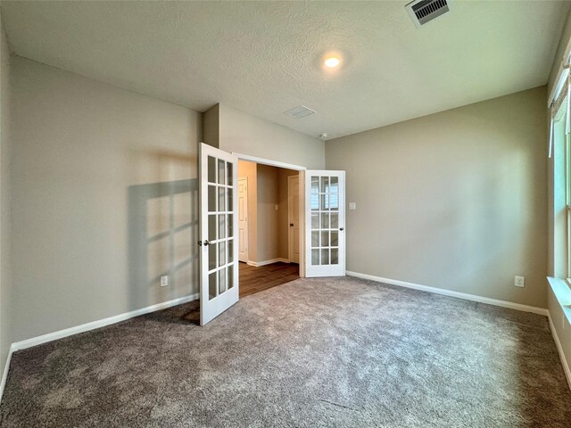 2115 Katalonia Ln, Fresno, TX 77545 - carpeted empty room featuring french doors, baseboards, and a textured ceiling