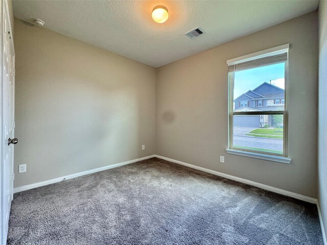 2115 Katalonia Ln, Fresno, TX 77545 - unfurnished room with baseboards, carpet, a smoke detector, and a textured ceiling