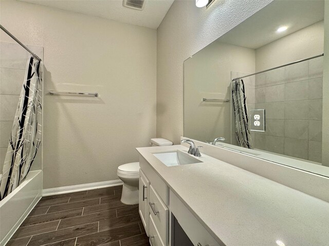 2115 Katalonia Ln, Fresno, TX 77545 - full bath with vanity, wood finish floors, toilet, shower / tub combo with curtain, and baseboards