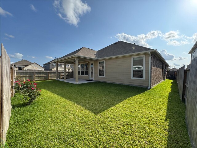 2115 Katalonia Ln, Fresno, TX 77545 - rear view of property featuring a patio area, brick siding, and a shingled roof