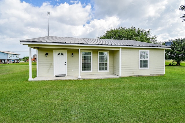 880 Swallow Dr, Palacios, TX 77465 - view of front of house featuring a front yard and a metal roof