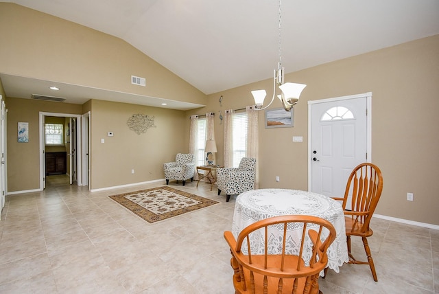 880 Swallow Dr, Palacios, TX 77465 - dining room with vaulted ceiling, a chandelier, and light tile patterned floors