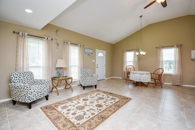 880 Swallow Dr, Palacios, TX 77465 - sitting room with ceiling fan, vaulted ceiling, light tile patterned flooring, and a chandelier