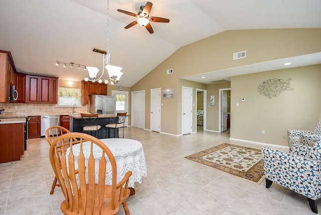 880 Swallow Dr, Palacios, TX 77465 - living room with a chandelier, ceiling fan, light tile patterned floors, and high vaulted ceiling
