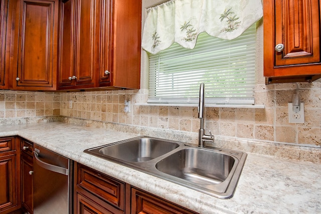 880 Swallow Dr, Palacios, TX 77465 - kitchen featuring stainless steel dishwasher, light countertops, and backsplash