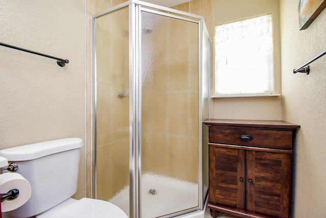 880 Swallow Dr, Palacios, TX 77465 - bathroom featuring a textured wall and a shower stall