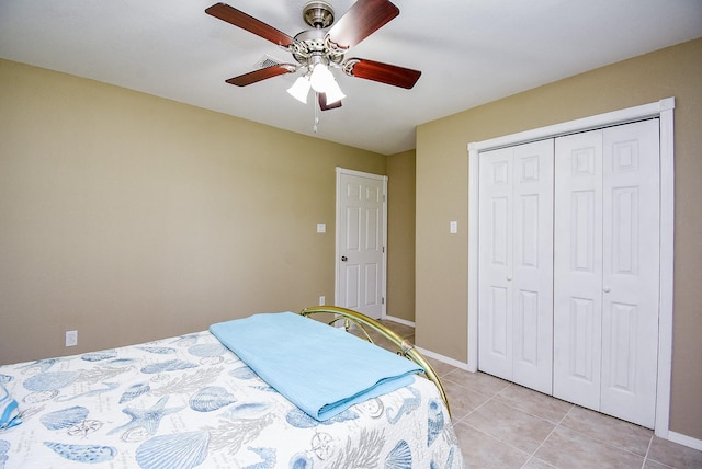 880 Swallow Dr, Palacios, TX 77465 - bedroom featuring light tile patterned floors, a ceiling fan, and a closet