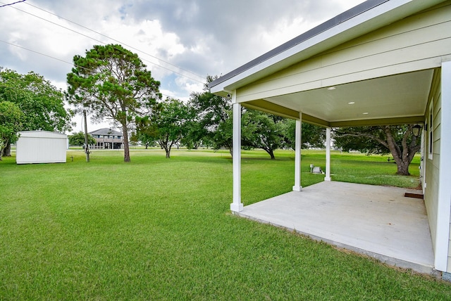 880 Swallow Dr, Palacios, TX 77465 - view of grassy yard featuring a patio area and a storage shed