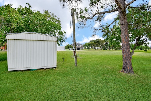 880 Swallow Dr, Palacios, TX 77465 - view of grassy yard featuring a shed