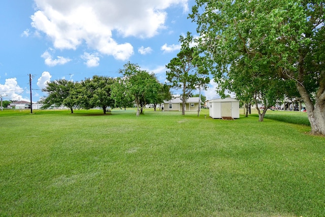 880 Swallow Dr, Palacios, TX 77465 - view of grassy yard featuring a storage shed