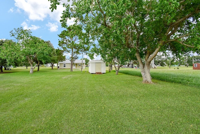 880 Swallow Dr, Palacios, TX 77465 - view of grassy yard featuring a storage shed