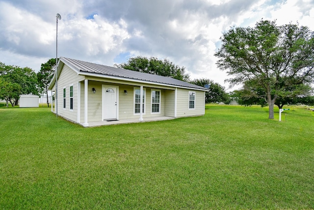 880 Swallow Dr, Palacios, TX 77465 - view of front of house featuring a front lawn and a metal roof