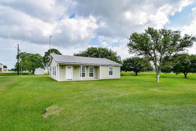 880 Swallow Dr, Palacios, TX 77465 - view of front of property with a front yard and a metal roof