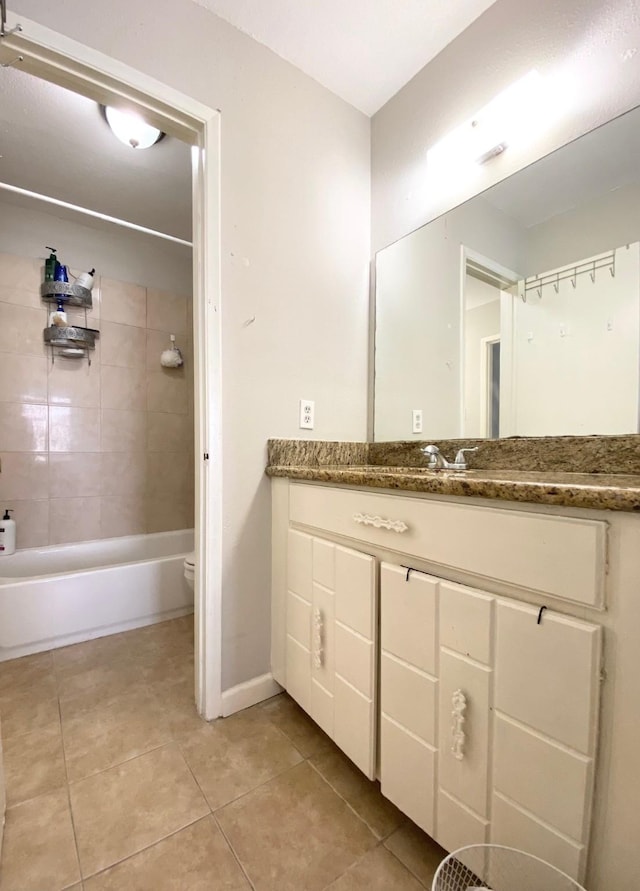 8323 Wilcrest Dr Unit 2006, Houston, TX 77072 - bathroom featuring tile patterned floors, vanity, toilet, baseboards, and bathtub / shower combination