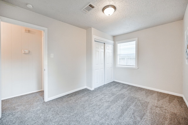9306 Chesterfield Dr, Houston, TX 77051 - unfurnished bedroom featuring carpet flooring, a textured ceiling, a closet, and baseboards