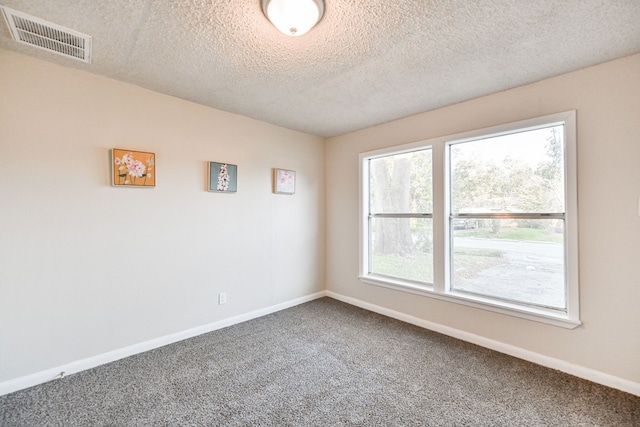 9306 Chesterfield Dr, Houston, TX 77051 - carpeted spare room with baseboards and a textured ceiling