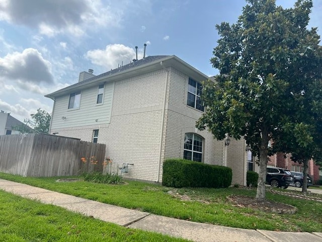 6603 Golden View Ct, Houston, TX 77083 - view of side of home featuring brick siding and a chimney