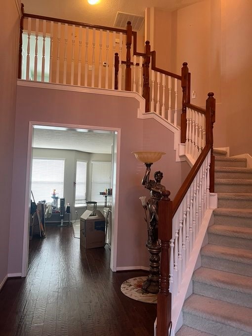 6603 Golden View Ct, Houston, TX 77083 - staircase featuring hardwood / wood-style floors, baseboards, and a high ceiling