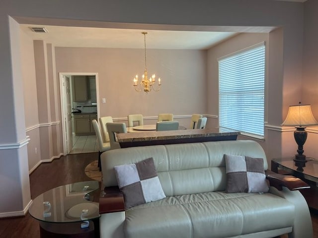 6603 Golden View Ct, Houston, TX 77083 - living area featuring a chandelier, dark wood-style flooring, and baseboards