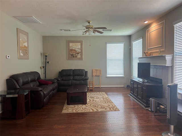 6603 Golden View Ct, Houston, TX 77083 - living room featuring a ceiling fan, dark wood-type flooring, and a fireplace