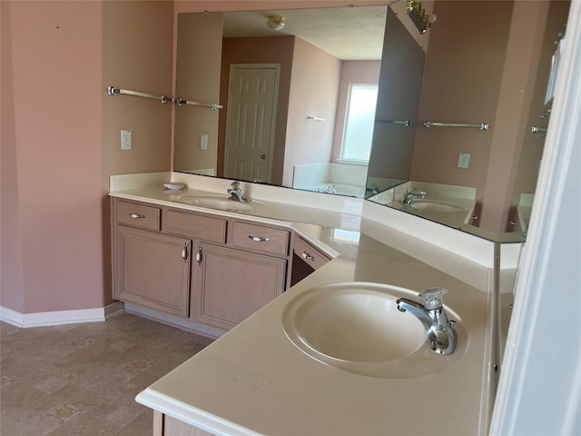 6603 Golden View Ct, Houston, TX 77083 - bathroom featuring double vanity and baseboards