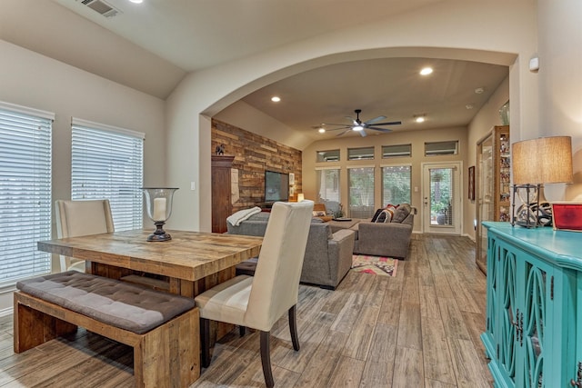 110 Mayhaven Ct, Montgomery, TX 77316 - dining space with arched walkways, ceiling fan, light wood finished floors, lofted ceiling, and healthy amount of natural light