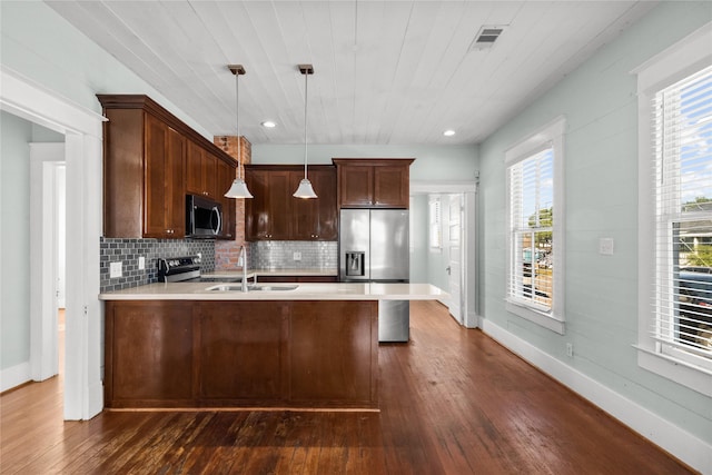 801 University Blvd, Galveston, TX 77550 - kitchen with appliances with stainless steel finishes, a sink, a peninsula, light countertops, and wood ceiling