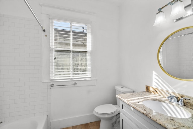 801 University Blvd, Galveston, TX 77550 - full bath featuring vanity, toilet, wood finished floors, shower / bath combination, and baseboards