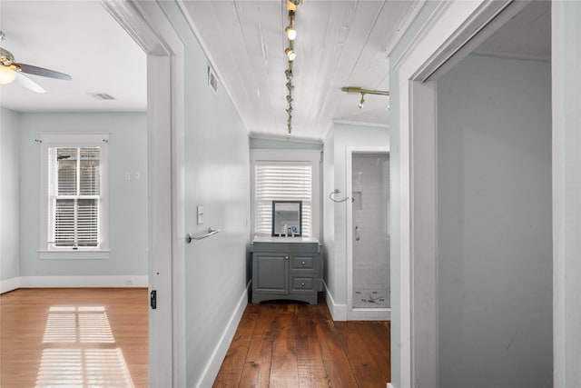 801 University Blvd, Galveston, TX 77550 - corridor with rail lighting, wood-type flooring, baseboards, and plenty of natural light