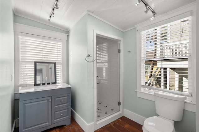 801 University Blvd, Galveston, TX 77550 - full bathroom featuring track lighting, wood-type flooring, baseboards, a shower stall, and ornamental molding