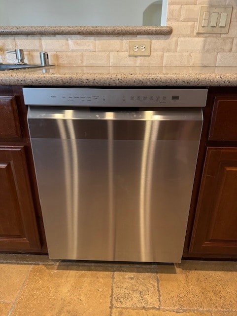 12515 Country Arbor Ln, Houston, TX 77041 - kitchen view of stainless steel dishwasher, backsplash, light stone countertops, and dark brown cabinetry
