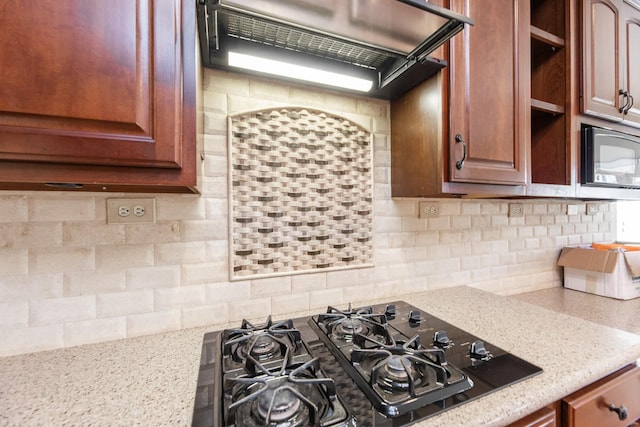 12515 Country Arbor Ln, Houston, TX 77041 - kitchen with black gas cooktop, decorative backsplash, and light stone counters