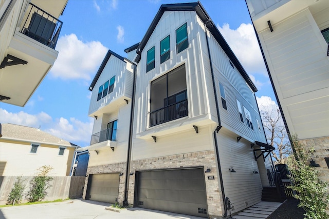 1407 W 23rd St, Houston, TX 77008 - view of front of property with brick siding, a garage, and board and batten siding